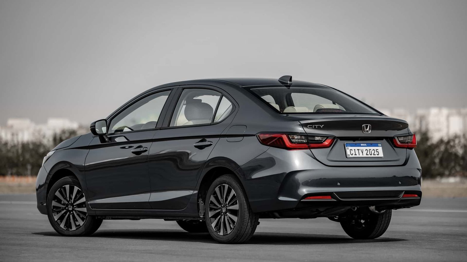 Honda City Sedan 2025 visto pela traseira em três quartos, com o carro inteiro